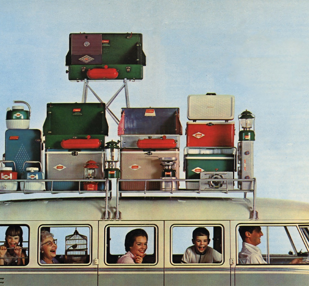 1960s Coleman advertisement showing a family station wagon with roof rack loaded with Coleman stoves, coolers, lanterns and camping products, family visible through windows smiling